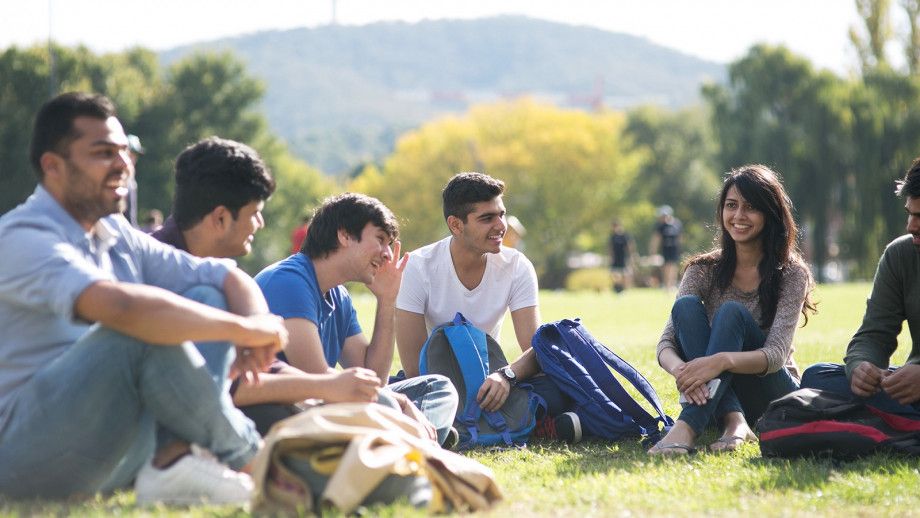 Students sit an Oval