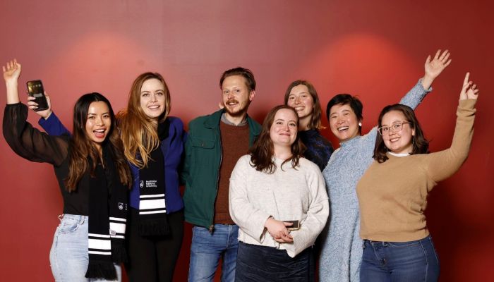 ANU Alumni Networks at Trivia, arms open wide with smiles